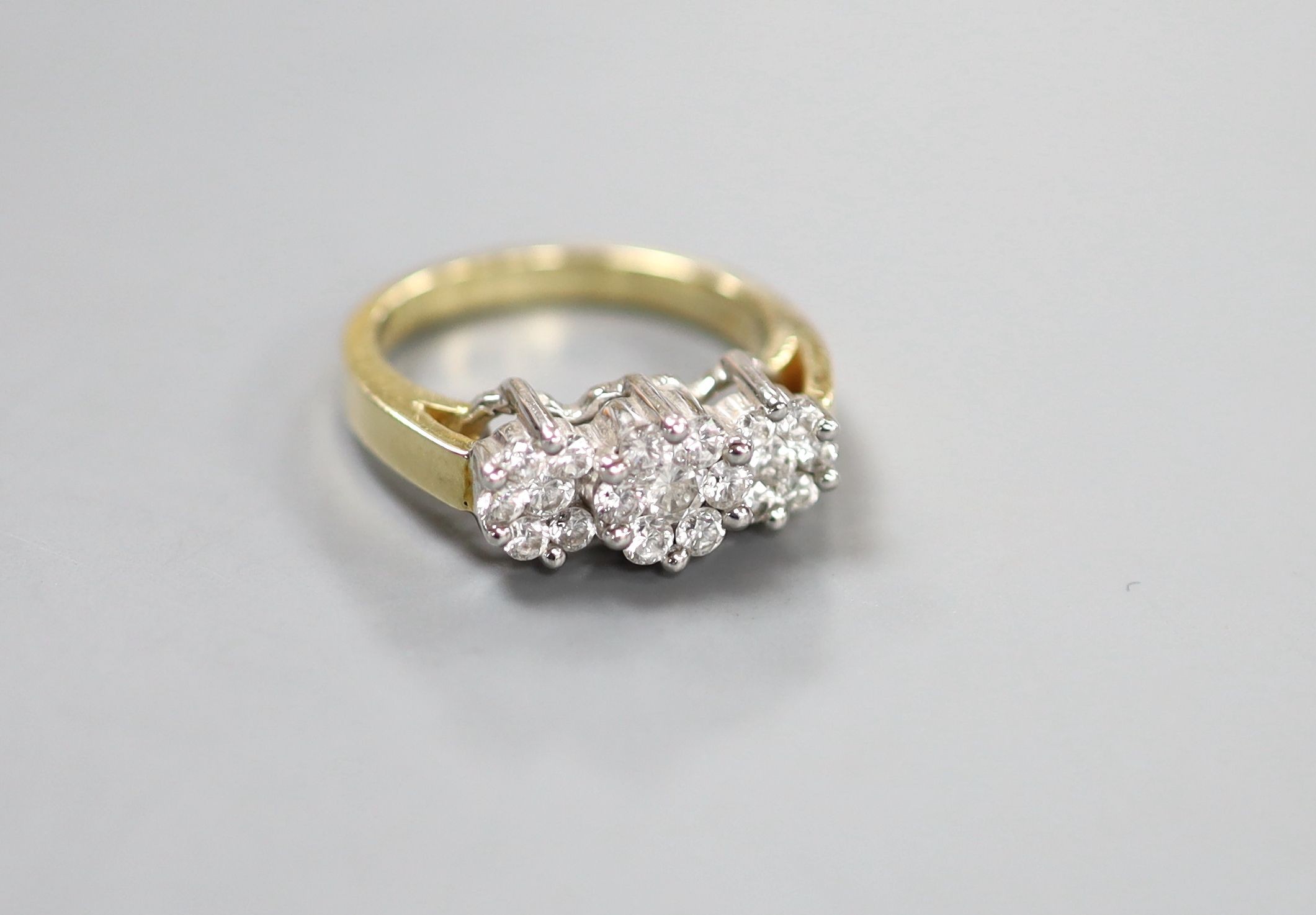 A modern 14k and diamond set triple cluster ring, size O, gross weight 6.3 grams.
